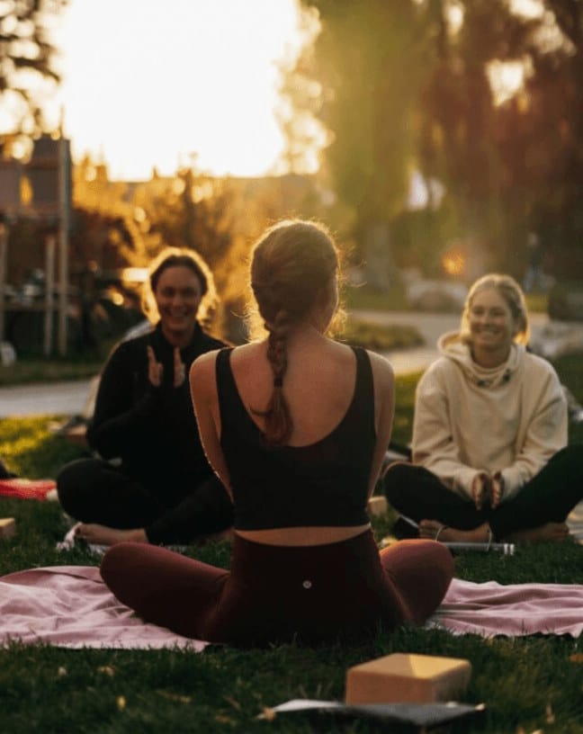 Group of people sitting on a lawn