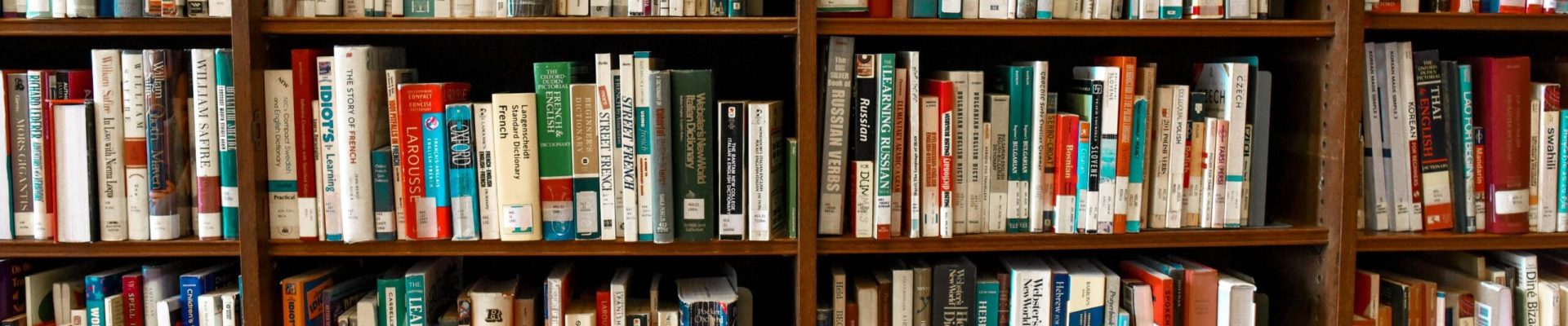 pexels photo 1370295 1370295 Vibrant library scene featuring wooden bookshelves filled with various books.